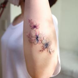 Sea buckthorn apple blossom and grass tattoo on the